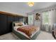 Charming bedroom with unique football-themed bedding and stylish black accent wall with timber trim at 1013 New Chester Ct, Apex, NC 27502