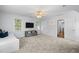 Large carpeted bonus room featuring neutral colors, a ceiling fan, media cabinet, and an exterior view at 1013 New Chester Ct, Apex, NC 27502