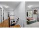 Bright hallway with wood floors and stairs leading to a bedroom with custom decor at 1013 New Chester Ct, Apex, NC 27502