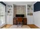 Home office with custom built-in shelving and cabinets, wooden desk, and comfortable chair at 1013 New Chester Ct, Apex, NC 27502