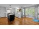 Bright kitchen with white cabinets, marble countertops, stainless steel appliances, and a dark island at 1013 New Chester Ct, Apex, NC 27502