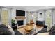 Cozy living room with a shiplap fireplace, hardwood floors, and plenty of natural light at 1013 New Chester Ct, Apex, NC 27502
