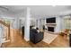 Bright living room with a fireplace, hardwood floors, and ample seating at 1013 New Chester Ct, Apex, NC 27502