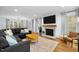Inviting living room with a fireplace, hardwood floors, and a large sectional sofa at 1013 New Chester Ct, Apex, NC 27502
