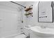 This bathroom features a tub and shower, sink, toilet, and shelves at 1014 E Club Blvd, Durham, NC 27704