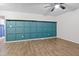 Large room with decorative blue wainscoting, light walls, and ceiling fan at 1014 E Club Blvd, Durham, NC 27704