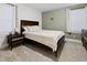 Cozy bedroom with wood-look accent wall, nightstand, and natural light at 1014 E Club Blvd, Durham, NC 27704