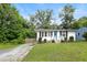 Charming home featuring a well-maintained lawn, inviting blue front door, and ample natural light at 1014 E Club Blvd, Durham, NC 27704