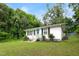 A quaint home featuring a well-manicured lawn, complemented by natural light and surrounding greenery at 1014 E Club Blvd, Durham, NC 27704