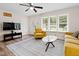 Inviting living room featuring wood floors, a ceiling fan, natural light, and neutral-colored furniture at 1014 E Club Blvd, Durham, NC 27704