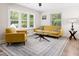 Bright living room with wood flooring, a glass coffee table, and comfortable seating arrangement at 1014 E Club Blvd, Durham, NC 27704