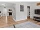 Open-concept living area with wood floors, modern décor, and a view into the updated kitchen at 1014 E Club Blvd, Durham, NC 27704