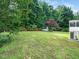 Spacious backyard with lush greenery, mature trees, and a well-maintained lawn, perfect for outdoor activities at 102 Heritage Ridge Ct, Knightdale, NC 27545