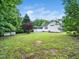 Expansive backyard features a well-maintained lawn and a charming screened-in porch for outdoor relaxation at 102 Heritage Ridge Ct, Knightdale, NC 27545