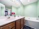 Bright bathroom with double vanity, garden tub, and fresh green walls at 102 Heritage Ridge Ct, Knightdale, NC 27545