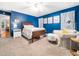 Cozy primary bedroom showcasing blue walls, a comfortable bed, and ample natural light for a relaxing ambiance at 102 Heritage Ridge Ct, Knightdale, NC 27545