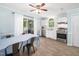 Bright dining area with white cabinets, stainless steel appliances, and a sliding door leading to the outdoors at 102 Heritage Ridge Ct, Knightdale, NC 27545