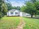 Charming single-story home with a well-manicured lawn and attached garage, nestled amongst mature trees at 102 Heritage Ridge Ct, Knightdale, NC 27545