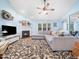Inviting living room with a fireplace, ceiling fan, plush sectional sofa, and a large floral area rug at 102 Heritage Ridge Ct, Knightdale, NC 27545
