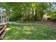 A lush, level backyard with a patio and a stone path creates a peaceful and inviting outdoor space at 1025 Kingsway Dr, Apex, NC 27502