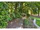 Backyard garden featuring a stone path and lush greenery, creating a serene and inviting outdoor space at 1025 Kingsway Dr, Apex, NC 27502
