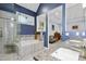 Modern bathroom featuring a tub, glass-enclosed shower, and double sink vanity with granite countertops at 1025 Kingsway Dr, Apex, NC 27502