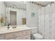 Cozy bathroom with a vanity, toilet, shower, and decorative floral accents at 1025 Kingsway Dr, Apex, NC 27502