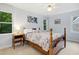 Comfortable bedroom featuring a queen-sized bed with two windows that allow ample natural light at 1025 Kingsway Dr, Apex, NC 27502