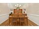 The dining room features hardwood floors and a china cabinet with glass doors and lighting at 1025 Kingsway Dr, Apex, NC 27502