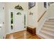 Inviting entryway with hardwood floors, decorative wreath, and staircase leading upstairs at 1025 Kingsway Dr, Apex, NC 27502