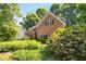 Charming brick home featuring lush landscaping and vibrant greenery in a well-maintained yard at 1025 Kingsway Dr, Apex, NC 27502