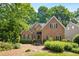 Charming brick home with lush landscaping, gabled roof, and inviting curb appeal at 1025 Kingsway Dr, Apex, NC 27502