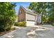 Exterior view of the home featuring an attached garage and solar panels at 1025 Kingsway Dr, Apex, NC 27502