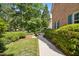 Brick home featuring manicured bushes and a sidewalk leading to the house, set in a lush, green neighborhood at 1025 Kingsway Dr, Apex, NC 27502