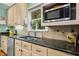 A sunlit kitchen boasts stainless steel appliances, granite counters, and light wood cabinets at 1025 Kingsway Dr, Apex, NC 27502