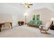 Spacious living room with comfortable seating, a desk, and bright natural light at 1025 Kingsway Dr, Apex, NC 27502