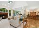 Open-concept living room with a fireplace, skylight, and seamless flow to the dining area at 1025 Kingsway Dr, Apex, NC 27502