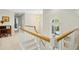 Bright stairway with white railings, carpeted steps, and natural light from a large window at 1025 Kingsway Dr, Apex, NC 27502