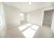 Well-lit bedroom with neutral carpet, a window, and a closet at 105 Ambergate Ct, Rocky Mount, NC 27804