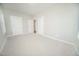 A bedroom with carpet and white walls has multiple doorways and windows with natural light at 105 Ambergate Ct, Rocky Mount, NC 27804