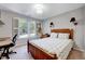 Bedroom with a window and shutters and a wood frame bed with printed comforter at 105 Wittenham Dr, Cary, NC 27519
