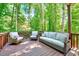 Wooden deck featuring outdoor seating and a view of the surrounding lush trees at 105 Wittenham Dr, Cary, NC 27519