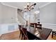 Elegant dining room with hardwood floors, decorative molding, and a view of the staircase at 105 Wittenham Dr, Cary, NC 27519
