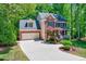 Spacious driveway leading to a brick home with attached garage and manicured landscaping at 105 Wittenham Dr, Cary, NC 27519