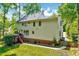 Side view of a two story home with a brick foundation and a deck at 105 Wittenham Dr, Cary, NC 27519