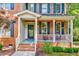 Inviting front porch with hanging plants and red-brick accents on a charming home at 105 Wittenham Dr, Cary, NC 27519