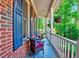 Relaxing front porch seating area with wicker chairs and hanging flower baskets at 105 Wittenham Dr, Cary, NC 27519