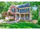Charming two-story brick home with a well-manicured lawn and inviting front porch at 105 Wittenham Dr, Cary, NC 27519