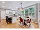 Modern kitchen with white cabinets, granite countertops, and a breakfast bar with seating at 105 Wittenham Dr, Cary, NC 27519