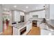 Modern kitchen with white cabinets, stainless appliances, stone countertops, and a central island at 105 Wittenham Dr, Cary, NC 27519
